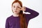Adorable little girl with red hair and freckles shows kissing face and peace kawaii sign. Cute ginger kid makes kawaii