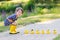 Adorable little girl with rubber ducks in summer park