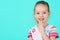 Adorable little girl smiling and showing off her first lost milk tooth. Cute preschooler portrait.