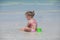 Adorable little girl in swimsuit playing at