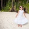 Adorable little girl on tropical beach vacation in