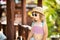 Adorable little girl at the tropical resort, sunny summer day