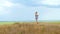 Adorable little girl in vintage dress standing on the hill. Child running in wild grass countryside rural landscape 4K.