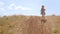 Adorable little girl in vintage dress standing on the hill. Child running in wild grass countryside rural landscape 4K.