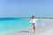 Adorable little girl walking along white sand Caribbean beach