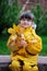 Adorable little girl in yellow raincoat