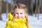 Adorable little girl in a yellow winter jacket