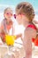 Adorable little girls during summer vacation. Kids playing with beach toys on the white beach