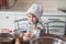adorable little kid in chef hat with whisk ready