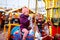 Adorable little kid girl riding on a carousel horse at Christmas funfair or market, outdoors.