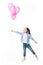 adorable little kid looking at pink balloons in hand