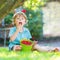 Adorable little preschool boy eating raspberries in home\'s garde