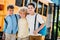 adorable little schoolboys embracing in front of school bus and looking