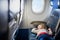 Adorable little toddler girl traveling by plane