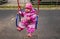 Adorable little toddler swinging on a swing in the playground