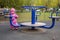 Adorable little toddler swinging on a swing in the playground