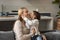 Adorable loving girl kissing happy smiling mom with love, gratitude