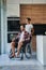 Adorable man with a physical disability resting with woman in their house