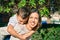 Adorable mother and son smiling happy on piggyback at the city