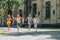 Adorable multicultural schoolchildren smiling while running in schoolyard