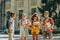 Adorable multicultural schoolchildren standing in schoolyard and holding books