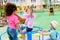 adorable multiethnic group of little kids riding on carousel