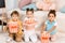 adorable multiethnic kids holding boxes with popcorn and looking
