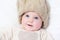 Adorable newborn baby wearing big knitted hat