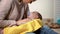 Adorable newborn with dummy lying in arms, lady touching belly to reduce colic