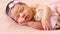Adorable newborn little baby in pink blanket