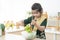 Adorable Pakistani little Muslim child girl in traditional clothes have fun making vegetables salad in mixing bowl, preparing