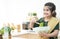 Adorable Pakistani little Muslim child girl in traditional clothes smiling making vegetables salad, preparing breakfast at home