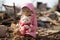 Adorable plush toy sit serenely amid the ruins of destroyed buildings.