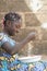 Adorable Portrait of Little African Girl Preparing Rice for Meal