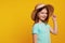 Adorable positive active girl kid wearing blue t shirt and stylish hat