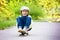 Adorable preschool child skateboarding on the street