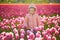 Adorable preschooler girl in beautiful blossoming tulip field