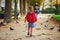 Adorable preschooler girl enjoying nice and sunny autumn day outdoors