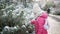 Adorable preschooler girl having fun in beautiful winter park on a snowy cold winter day