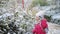 Adorable preschooler girl having fun in beautiful winter park on a snowy cold winter day