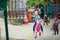 Adorable preschooler girl on a horse of traditional Parisian vintage merry-go-round where children have to catch and collect rings