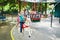 Adorable preschooler girl on a horse of traditional Parisian vintage merry-go-round where children have to catch and collect rings