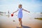 Adorable preshooler girl playing on the sand beach at Atlantic coast of Brittany, France