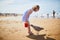 Adorable preshooler girl playing on the sand beach at Atlantic coast of Brittany, France