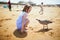 Adorable preshooler girl playing on the sand beach at Atlantic coast of Brittany, France