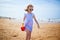 Adorable preshooler girl playing on the sand beach at Atlantic coast of Brittany, France