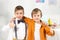 Adorable preteen boys looking at camera, hugging and showing thumbs up during birthday party.
