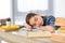 adorable preteen child sleeping on books