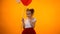 Adorable preteen girl with holding air balloon and flirting, smiling to camera