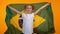 Adorable preteen girl jumping with brazilian flag cheering for favorite team
